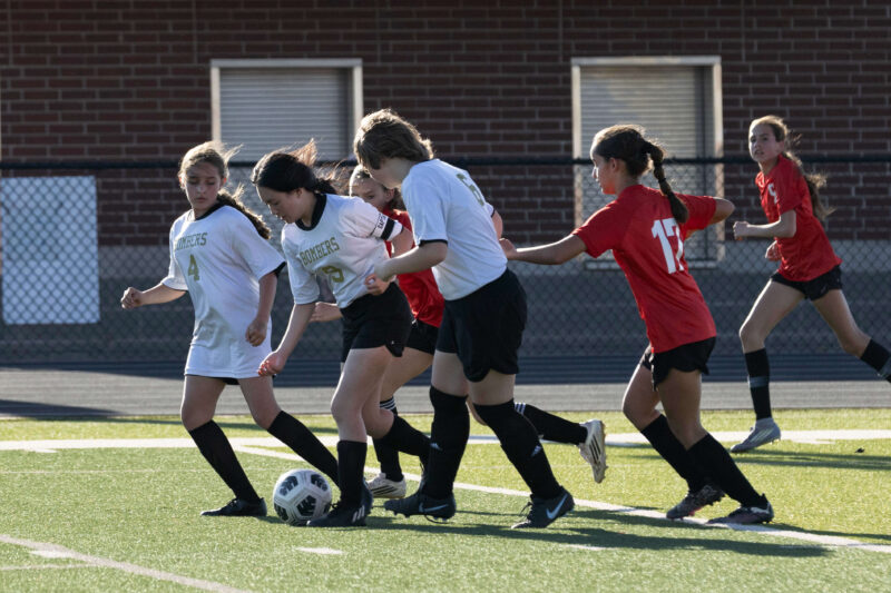 boys soccer players competing for ball midfield Midwest City Oklahoma