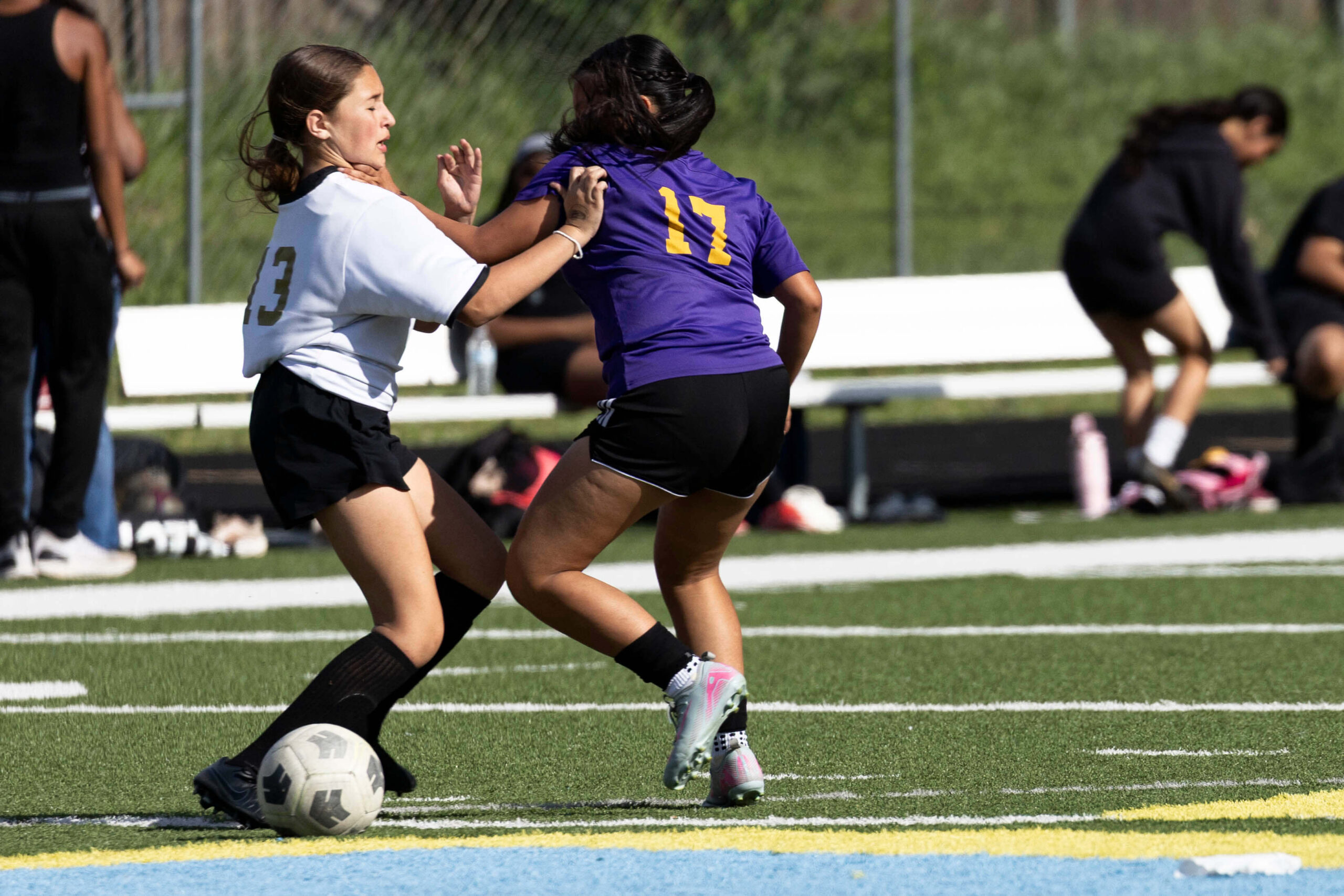 girls soccer player shielding ball from defender during match Midwest City Oklahoma