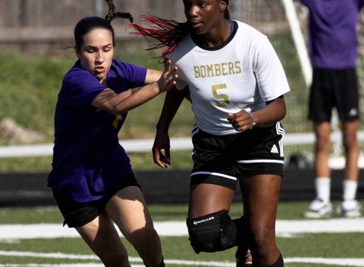 girls soccer defender chasing attacker with ball Midwest City Oklahoma sports photography