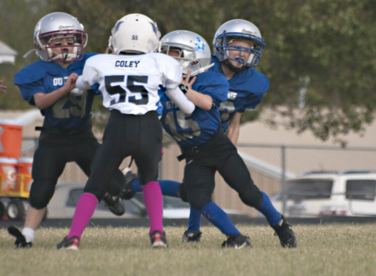 youth football players colliding at line of scrimmage during play Guthrie Oklahoma sports photography