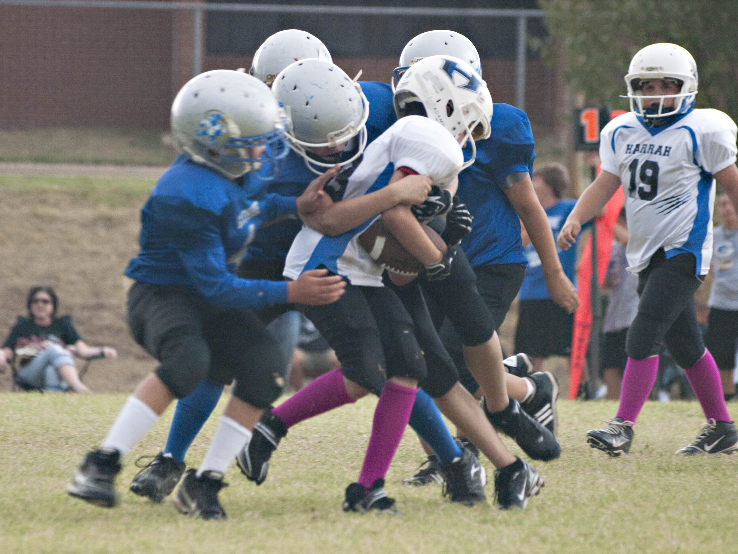 youth football players making group tackle during game Guthrie Oklahoma sports photography
