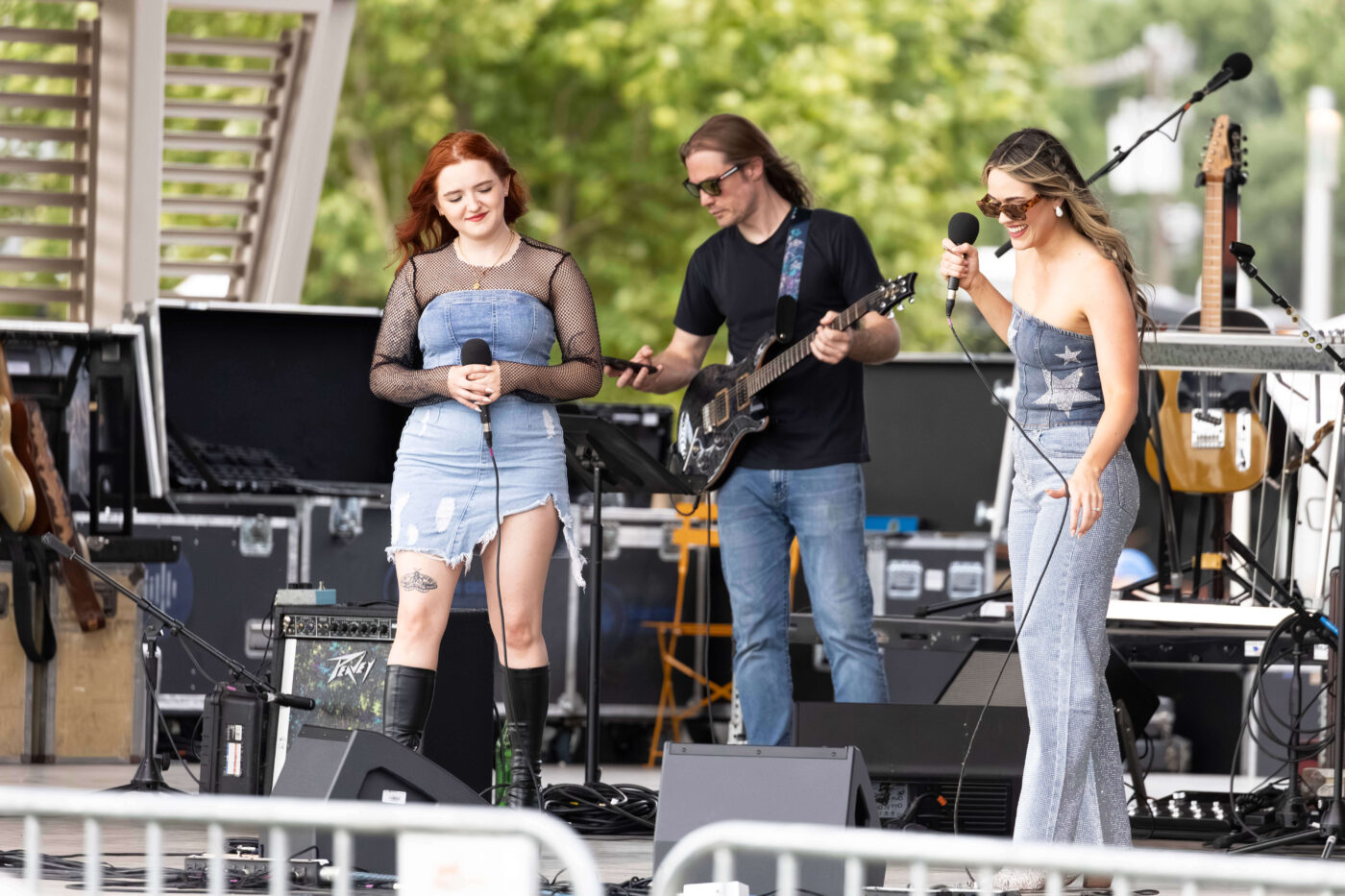 Members of OK3 perform together on stage during a live music set at the Route 66 Centennial Celebration.