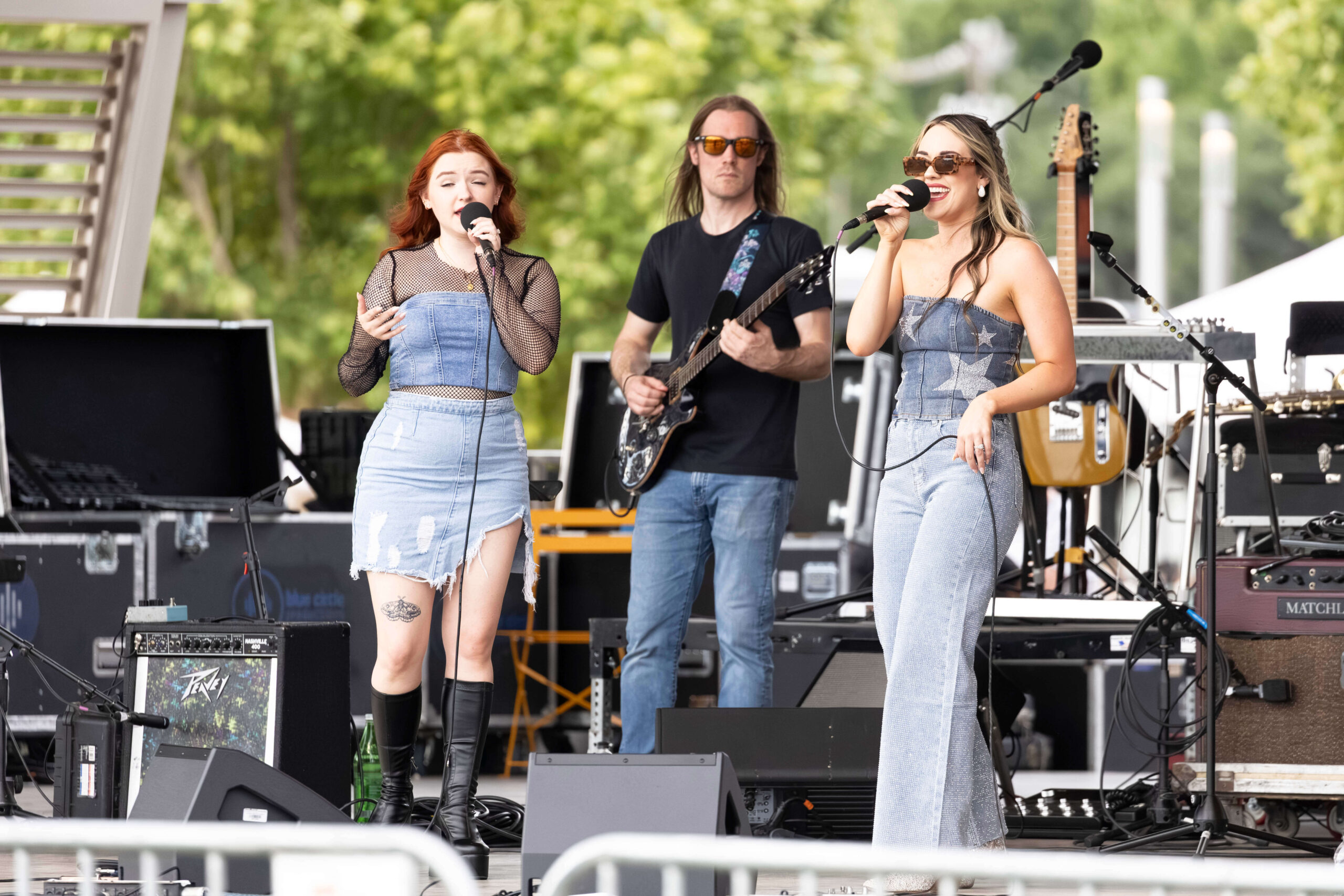 OK3 vocalist walks across the stage holding a microphone during a live performance.