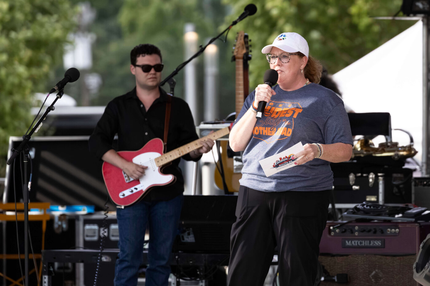 Guitarist performs on stage with a bright pink electric guitar during Bailey Rae's set at the Route 66 Centennial Celebration in Oklahoma City.