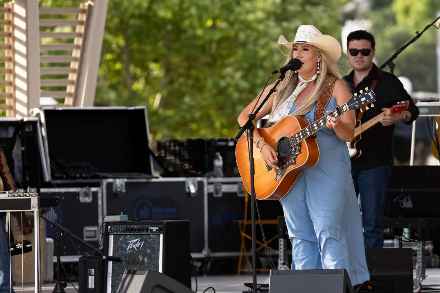 Event host addresses the crowd on stage before Bailey Rae's performance at the Route 66 Centennial Celebration.