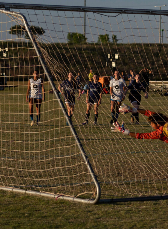 Amarillo Rush player prepares to celebrate after scoring a penalty kick past the diving West Side Alliance goalkeeper during a U16 Girls Gold Division match at the 2026 NOKC Spring Finale