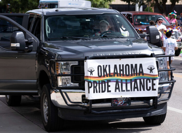Vehicle displaying an Oklahoma Pride Alliance banner during the parade.
