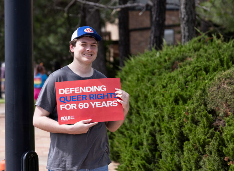 Person holding a sign supporting LGBTQ rights during the Oklahoma City Pride Parade.