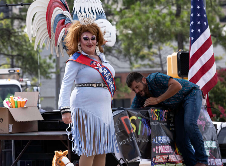 Crowned performer waves from a parade float during the Oklahoma City Pride Parade.
