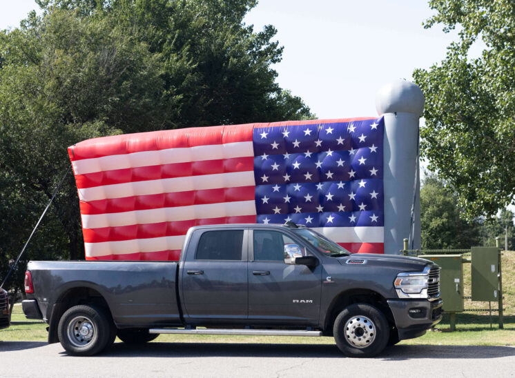 Large inflatable American flag behind a parked pickup truck at Yukon Freedom Fest.