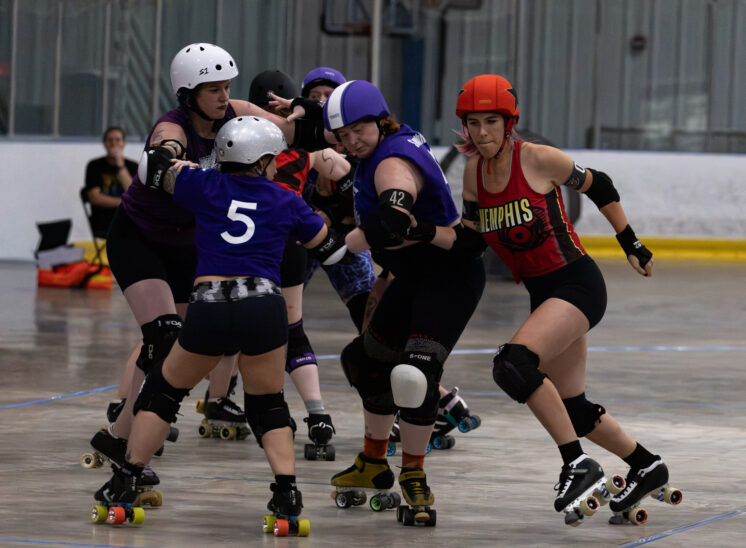 Twister City Lightning Quads blockers form a defensive wall as a Memphis B-Sides skater approaches the pack.