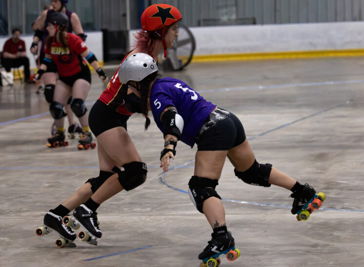 Twister City skater #5 drives forward while being challenged by a Memphis B-Sides skater.