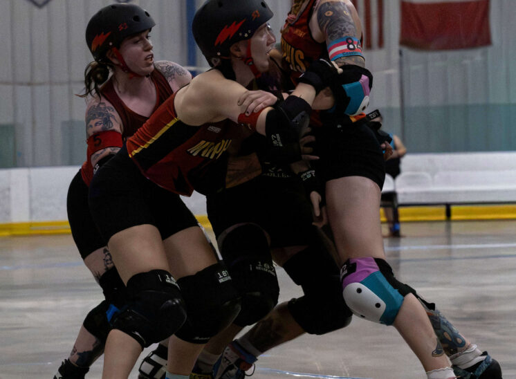 Memphis A blockers form a defensive wall against a Twister City skater during derby action.