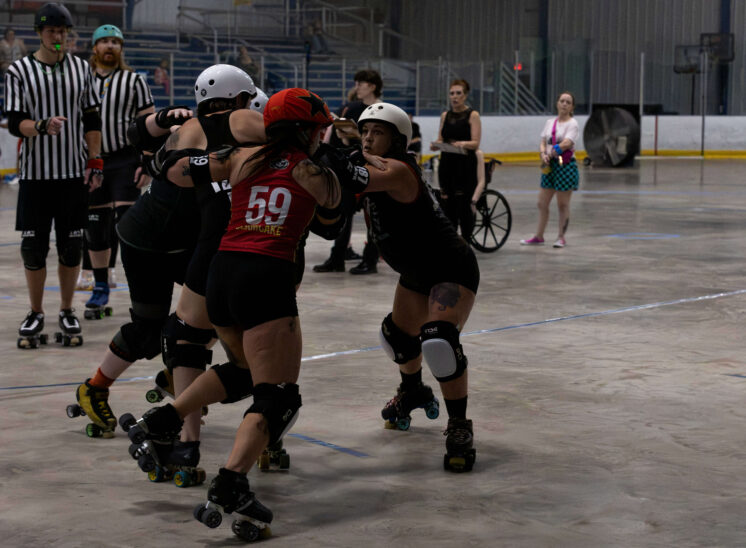 Twister City and Memphis A skaters lock up in a physical battle near the center of the track.